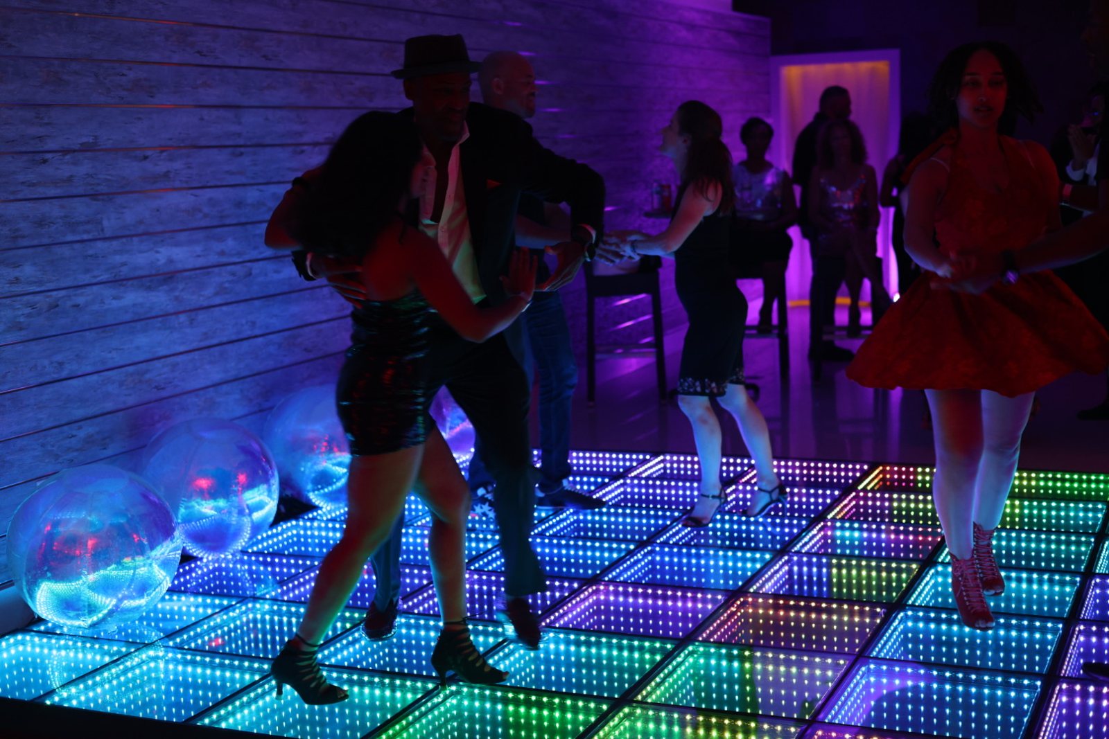 Dance partners enjoying a colorful Latin social