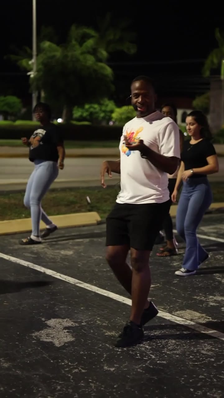 Dancers practicing salsa steps together outdoors